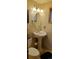 Updated bathroom with pedestal sink, toilet, and oval mirror at 8120 S Jay Dr, Littleton, CO 80128