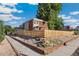 Brick home with a fenced yard and landscaping at 3560 N Adams St, Denver, CO 80205