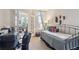 Small bedroom with daybed, office space, and French doors at 7865 Vallagio Ln # 207, Englewood, CO 80112