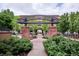 Attractive community entrance with landscaping and a pergola at 7865 Vallagio Ln # 207, Englewood, CO 80112