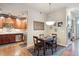 Bright dining area with hardwood floors and kitchen access at 7865 Vallagio Ln # 207, Englewood, CO 80112