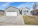 Single-story home with attached garage and landscaping at 7881 St Vrain Dr, Frederick, CO 80530