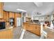 Bright kitchen features wood cabinets, tile flooring, and stainless steel appliances at 11097 S Wallace Ave, Conifer, CO 80433