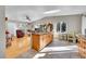 Open kitchen with oak cabinets, island, and view into the living room at 11097 S Wallace Ave, Conifer, CO 80433