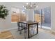 Modern dining area with a wooden table, black chairs, and access to a patio at 2623 W 26Th Ave # 2, Denver, CO 80211