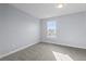 Bright bedroom with a window and gray carpet at 14314 E Hawaii Cir # D, Aurora, CO 80012