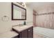 Clean bathroom with neutral tile, granite countertop vanity and bathtub at 7902 Meade St # C10, Westminster, CO 80030