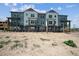 Modern townhome community with multiple units and balconies at 6940 Merseyside Ln, Castle Pines, CO 80108
