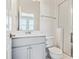 Modern bathroom with gray vanity, white toilet, and glass-enclosed shower at 6940 Merseyside Ln, Castle Pines, CO 80108