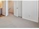 Carpeted bedroom with a door open to the adjacent bathroom at 6940 Merseyside Ln, Castle Pines, CO 80108