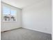 Unfurnished bedroom with plush carpeting and large windows at 6940 Merseyside Ln, Castle Pines, CO 80108