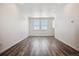 Bright bonus room with wood-style flooring and large windows at 6940 Merseyside Ln, Castle Pines, CO 80108
