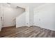 View of the foyer with wood-look flooring, white walls, and staircase at 6940 Merseyside Ln, Castle Pines, CO 80108