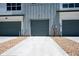 Attached two-car garage with gray door and gravel driveway at 6940 Merseyside Ln, Castle Pines, CO 80108