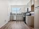 Modern kitchen with gray cabinets, stainless steel appliances, and tile backsplash at 6940 Merseyside Ln, Castle Pines, CO 80108
