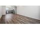 Spacious living area with wood-style flooring and view into the adjoining kitchen at 6940 Merseyside Ln, Castle Pines, CO 80108
