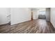 Open living area with wood-style flooring and view of the kitchen at 6940 Merseyside Ln, Castle Pines, CO 80108