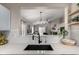 Kitchen features a farmhouse sink and herringbone backsplash at 11353 Jersey Way, Thornton, CO 80233