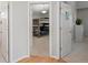 Hallway with doors to bedrooms and hardwood floors at 11285 Deerfield Dr, Firestone, CO 80504