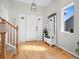 Bright entryway with hardwood floors and a wooden bench at 11285 Deerfield Dr, Firestone, CO 80504