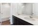 Double vanity bathroom with dark cabinets and a shower/tub combo at 5891 Red Barn Ave, Mead, CO 80504