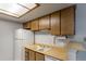 View of kitchen sink, countertop, and wood cabinets at 3462 S Eagle St # 201, Aurora, CO 80014