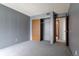 Bedroom with wood closet doors and access to bathroom at 3462 S Eagle St # 201, Aurora, CO 80014