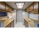 Bright kitchen with wood cabinets, white appliances, and tile floor at 3462 S Eagle St # 201, Aurora, CO 80014