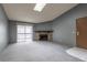 Living room with fireplace, carpet, and access to balcony at 3462 S Eagle St # 201, Aurora, CO 80014