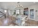 Modern kitchen with white cabinets, large island, and open concept at 1177 Sugarloaf Ln, Erie, CO 80516