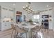 Large kitchen island with seating for six and modern light fixture at 1177 Sugarloaf Ln, Erie, CO 80516