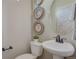 Clean bathroom featuring a pedestal sink and decorative wall accents at 1177 Sugarloaf Ln, Erie, CO 80516