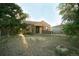 A beige ranch house with a front yard and mature trees at 7261 Magnolia St, Commerce City, CO 80022