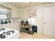 Kitchen with white cabinets, gas stove and a rolling cart at 7261 Magnolia St, Commerce City, CO 80022