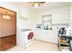 Kitchen with white cabinets, gas stove, and window above the sink at 7261 Magnolia St, Commerce City, CO 80022