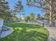 Landscaped backyard with grassy lawn and gravel border at 261 Lafayette St, Louisville, CO 80027