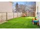 Fenced backyard with artificial turf and play equipment at 2565 S Milwaukee St, Denver, CO 80210