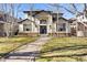 Charming two-story home with landscaped yard and stone walkway at 2565 S Milwaukee St, Denver, CO 80210