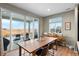 Dining area with a large wooden table, sliding glass doors to a patio, and wood floors at 6540 Copper Dr, Frederick, CO 80516