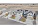 Aerial view of house and neighborhood with solar panels at 244 Chipeta Way, Lochbuie, CO 80603