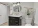 Basement bathroom with dark vanity, gold accents, and marble tile at 1553 Cherry St, Denver, CO 80220