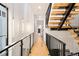 Modern hallway with light wood floors and glass railing at 3429 Lawrence St, Denver, CO 80205