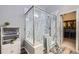 Large walk-in shower with marble tile and glass enclosure at 9806 W Hinsdale Pl, Littleton, CO 80128