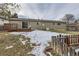 Backyard with small shed and partially snow-covered lawn at 6526 S Cherry Way, Centennial, CO 80121