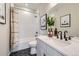 Stylish bathroom with black hexagon tile floor, white vanity, and bathtub at 9649 Browns Peak Cir, Littleton, CO 80125