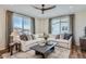 Cozy living room with a sectional sofa, coffee table, and large windows at 9649 Browns Peak Cir, Littleton, CO 80125