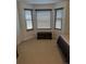 Bright bedroom featuring a bay window with blinds and a built-in storage chest at 56805 E 33Rd Pl, Strasburg, CO 80136