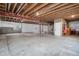 Unfinished basement with storage shelving and open space at 7470 Blue Water Ln, Castle Rock, CO 80108