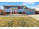 Ranch style home with red door and attached garage at 7927 Eaton St, Arvada, CO 80003