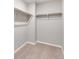 Large walk-in closet with double hanging rods and neutral carpeting at 14100 Black Sedge Cir, Parker, CO 80134